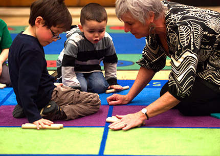Children and Teacher with Rolling Sticks