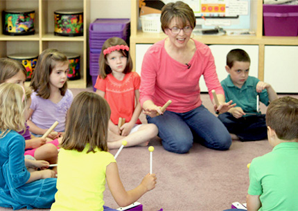 Children Making Music with Teacher