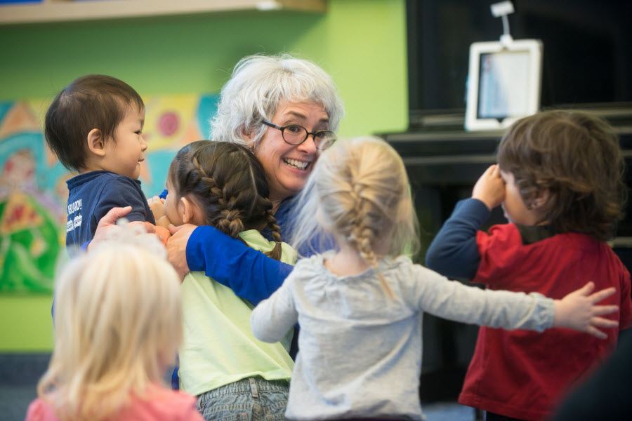 Kids Hugging Teacher
